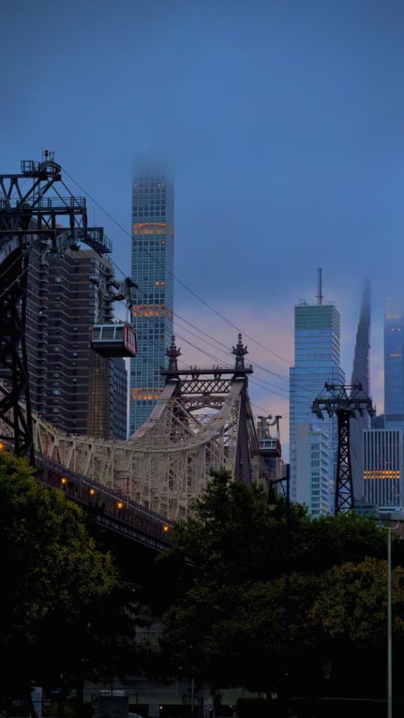 Roosevelt Island tram and the Queensboro Bridge at dusk.